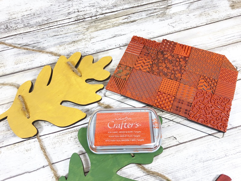 Build a crazy quilt pattern on a stamp block with Faux Quilted Red Rubber Stamp sets for the Leaves Door Decor